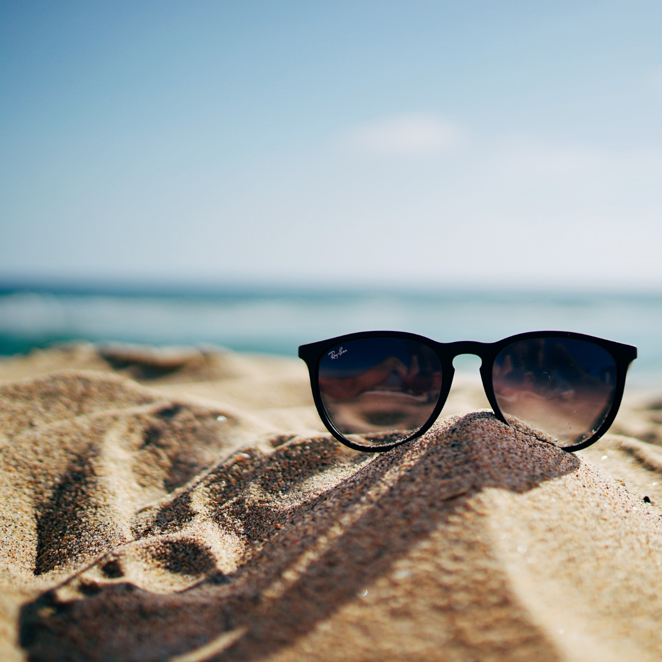 Sunglasses on sand at beach