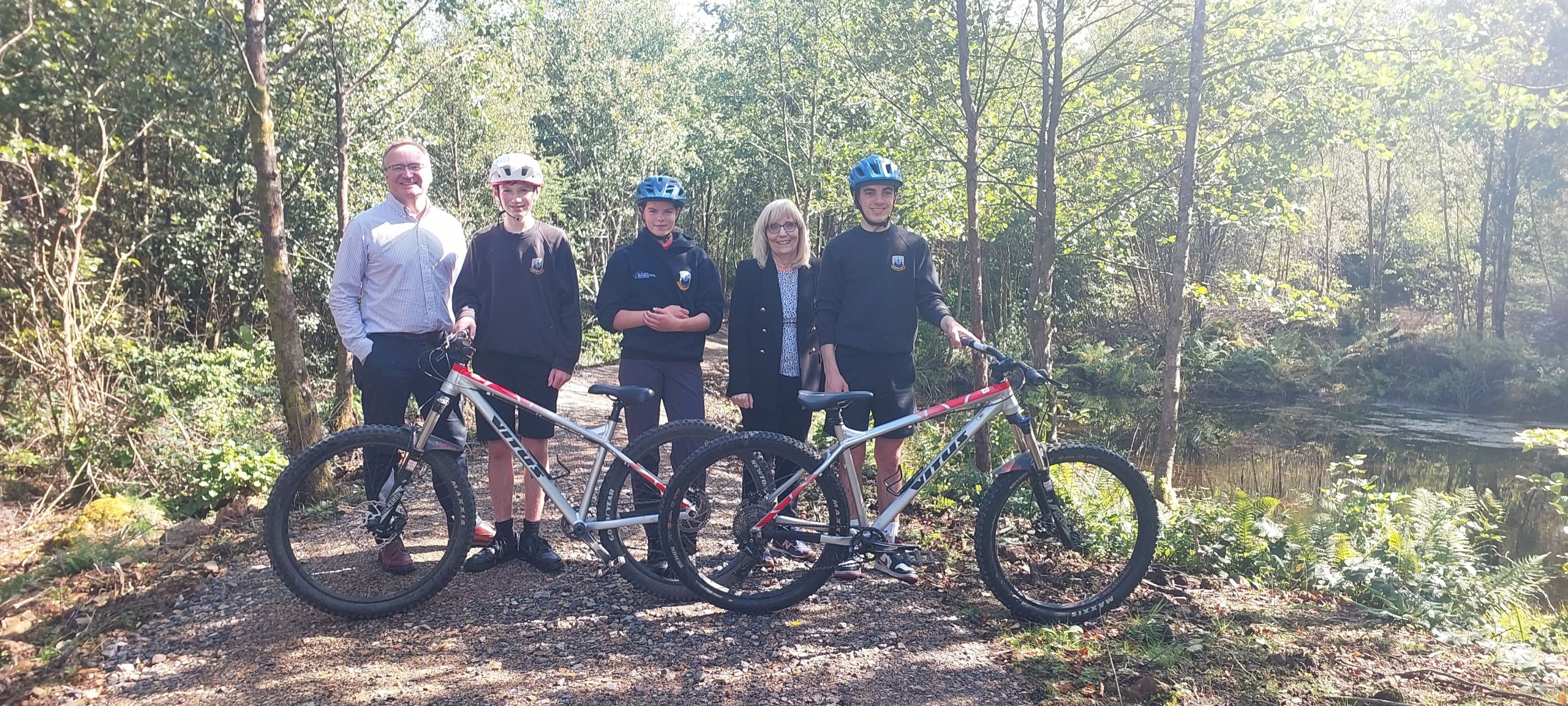 Marie Burns and Craig Hatton with Arran High pupils on their bikes at Dyemill all-weather bike park