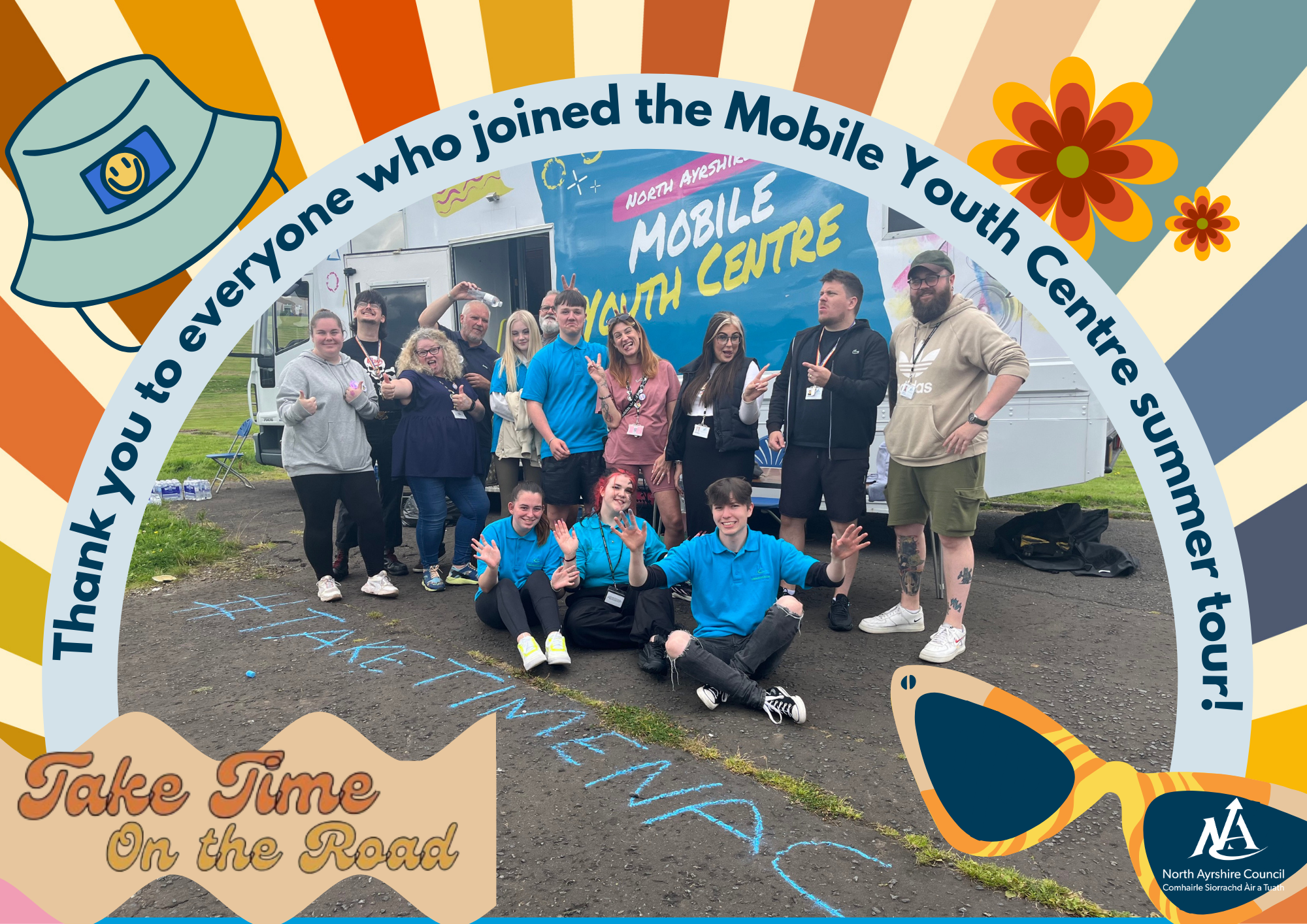 group of colleagues in front of a mobile youth centre bus with banner reading 'thank you to everyone who came to the Mobile Youth Centre Summer Tour' and a sunshine with rays graphic