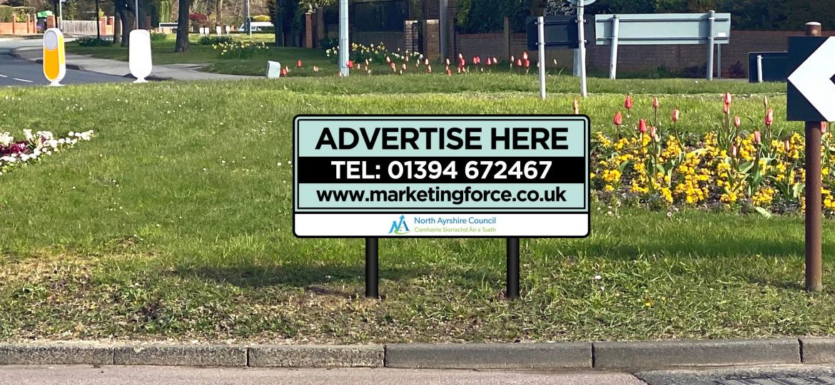 An advertising sign on a roundabout