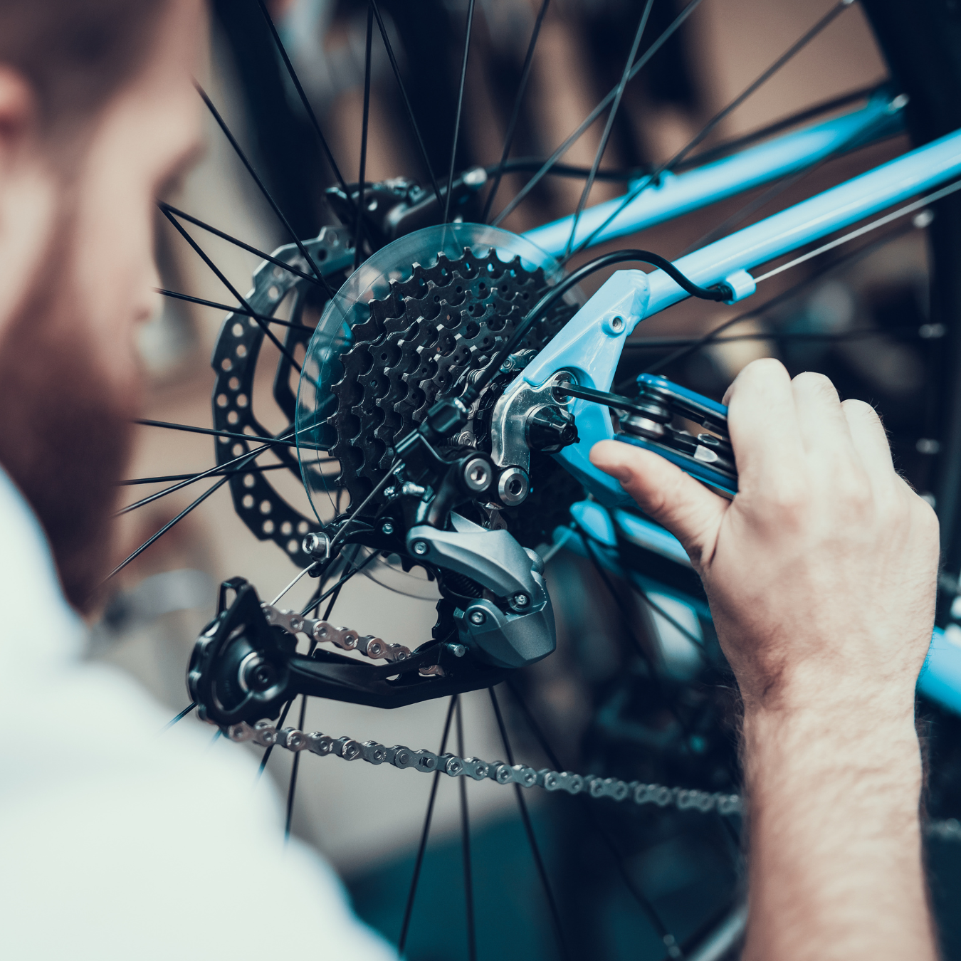 Person repairing bicycle chain