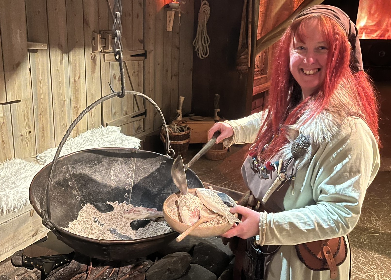 Making fish inside longhouse of the Viking Experience, Largs