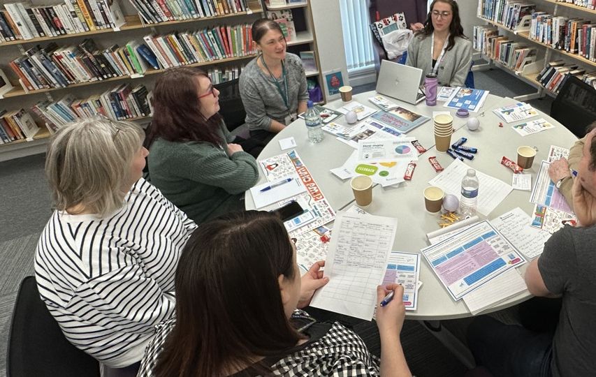 Stevenston Library Session with Corporate Parenting team with bookcase behind attendees