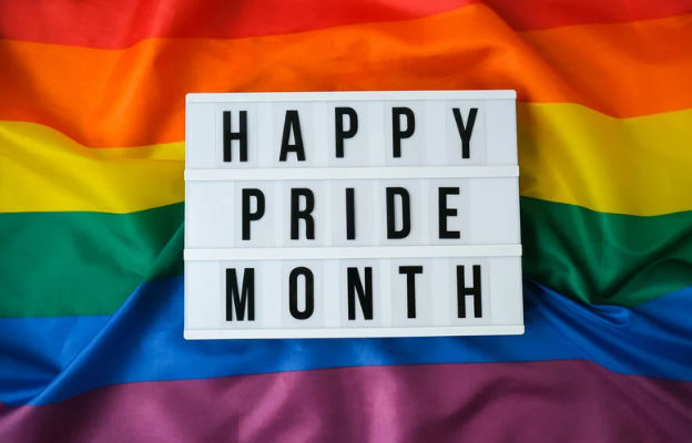 Happy Pride Month sign with pride rainbow flag