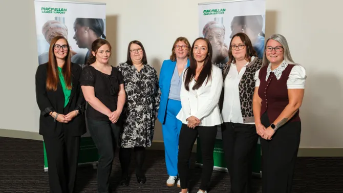 Group of women standing in front of Macmillan cancer support banners