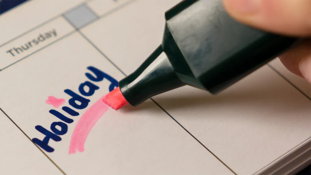 A pink highlighter underlining the word holiday in a calendar