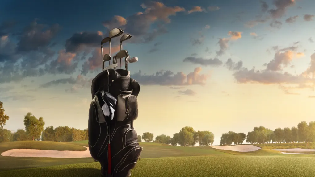 Golf clubs on lawn of golf course
