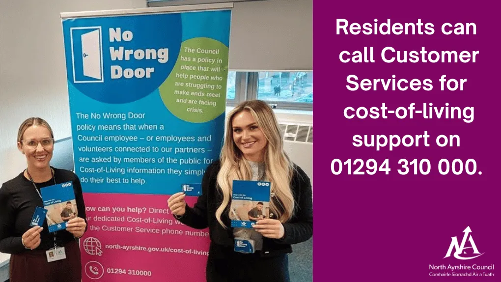 Two women standing next to a pop-up banner advertising the Council's No Wrong Door policy