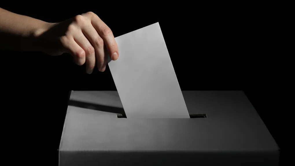 Envelope being posted into ballot box