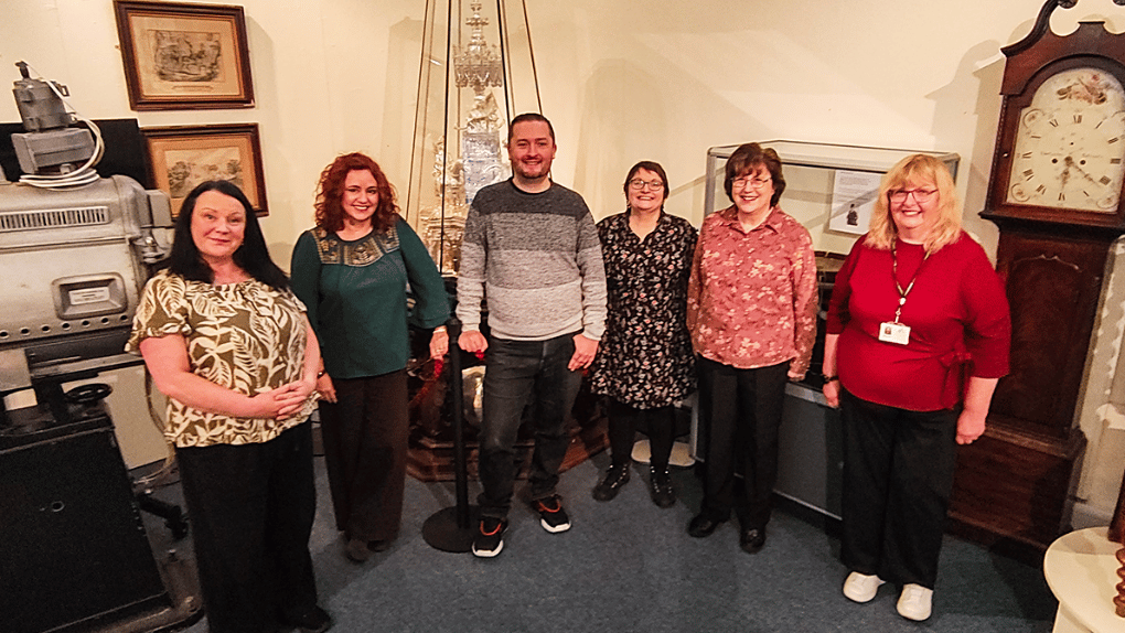 A group of six people standing alongside each other