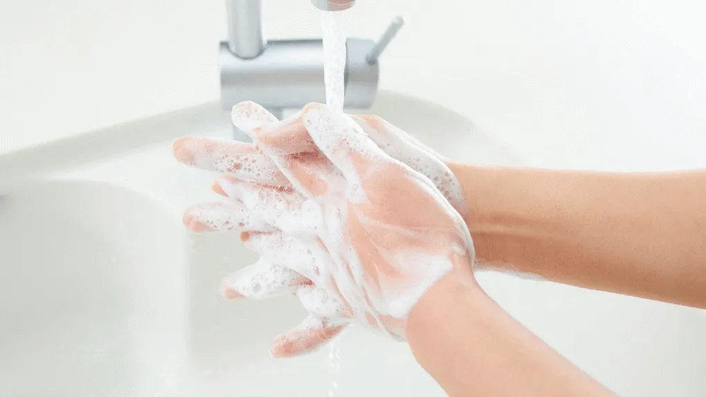 A person washing their hands with soap and water